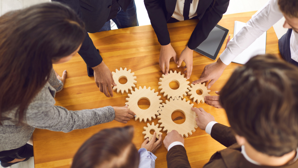 a group of business people working together on a wooden table