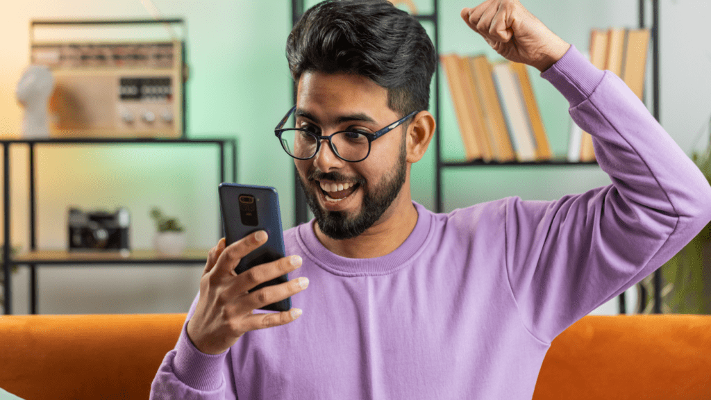 a person sitting on a couch and holding up their phone