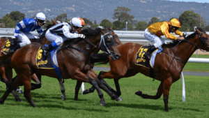 a group of jockeys racing horses on a track