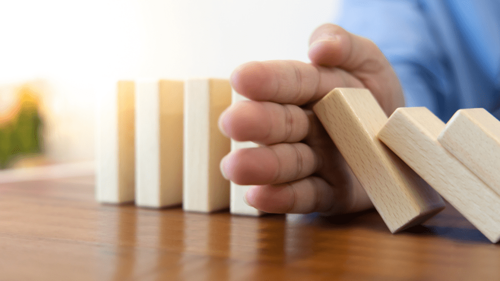 a person is placing wooden blocks on a table