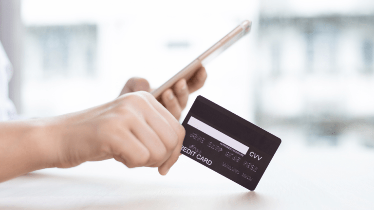 a person using a smartphone to pay a credit card