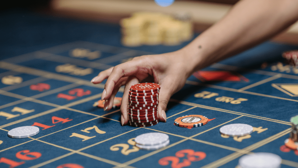 a person holding a casino chips