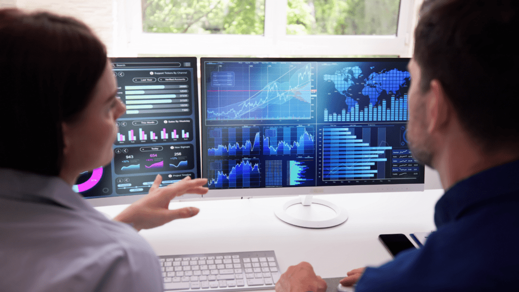 Two people pointing at a computer screen