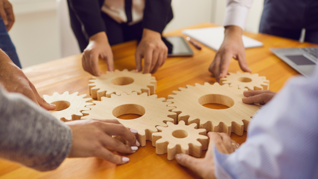 a group of business people working together on a wooden table