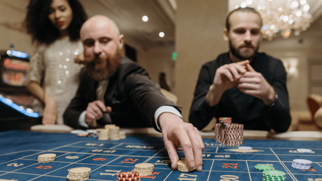 a group of people playing casino roulette