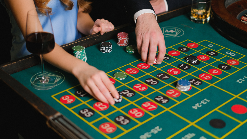 a group of people playing roulette at a casino table