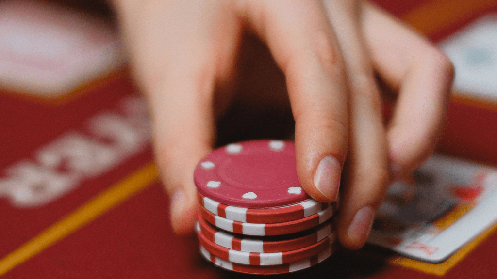 a person holding a casino chips