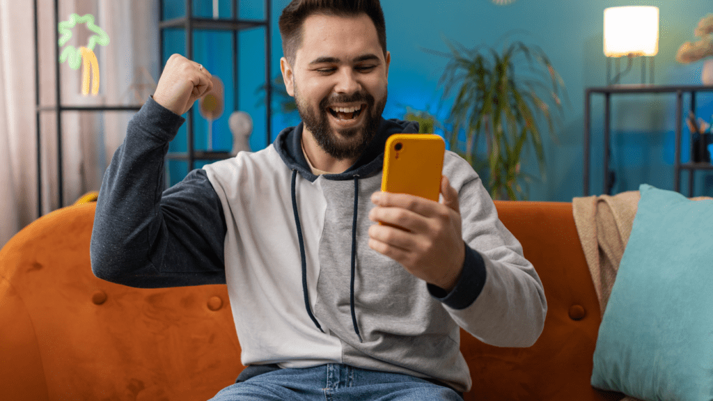 a person sitting on a couch and holding up their phone