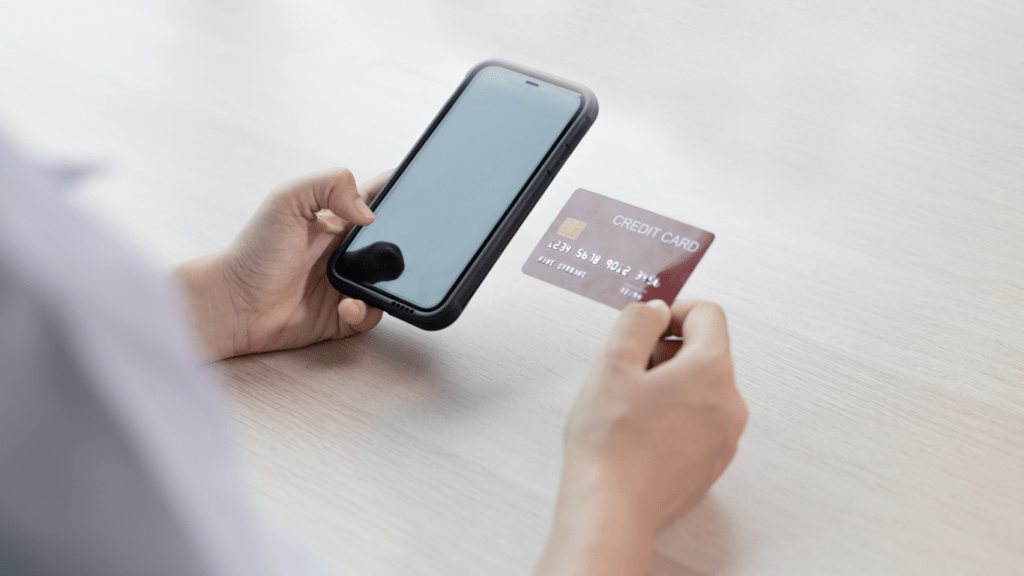 a person using a smartphone to pay a credit card